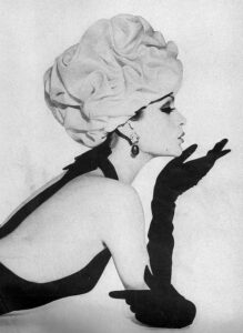 a woman in a turban and gloves